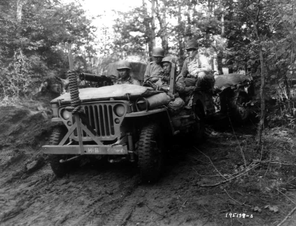 jeepof442ndregimentalcombatteamcrawlsthroughaforest.jpg