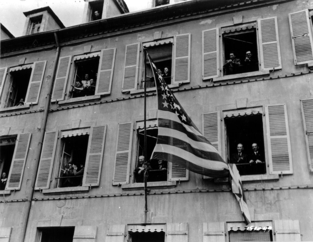 usflagfliesfrombuildingliberationofcherbourgceremony.jpg